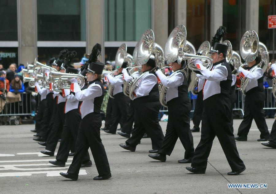 People attend the 88th Macy's Thanksgiving Day Parade in New York, the United States, Nov. 27, 2014.