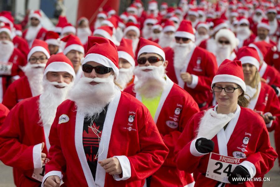 Participants dressed as Santa Claus take part in the 2014 Santa Race in Hamilton, Ontario, Canada, Nov. 30, 2014. 