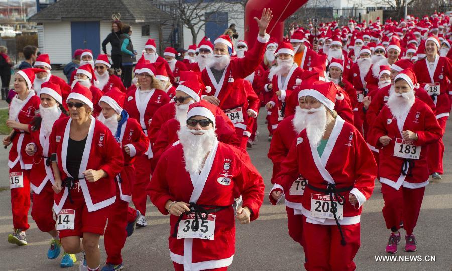 Participants dressed as Santa Claus take part in the 2014 Santa Race in Hamilton, Ontario, Canada, Nov. 30, 2014.