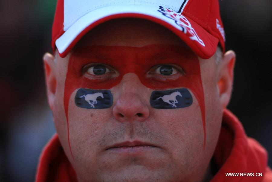 A football fan poses during CFL's 102nd Grey Cup finals in Vancouver, Canada, Nov. 30, 2014. Calgary Stampeders defeated Hamilton Tiger-Cats and captured 102nd Grey Cup.