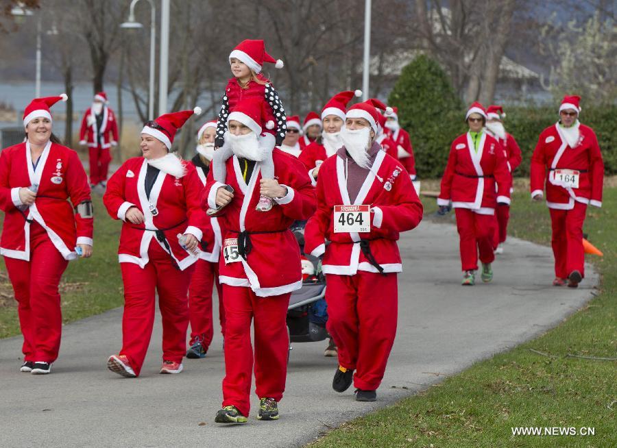 Participants dressed as Santa Claus take part in the 2014 Santa Race in Hamilton, Ontario, Canada, Nov. 30, 2014. 