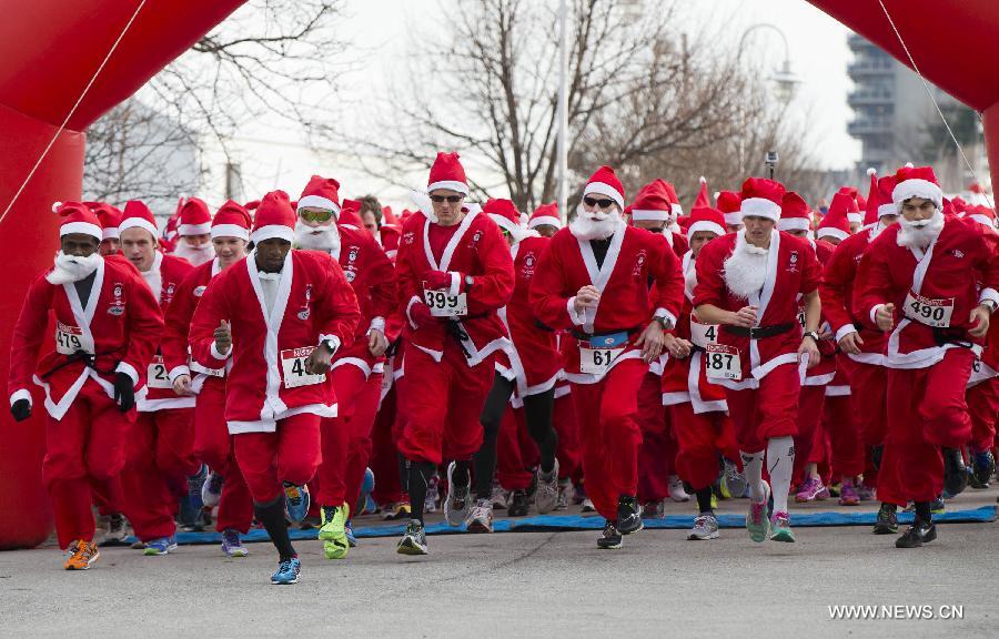 Participants dressed as Santa Claus take part in the 2014 Santa Race in Hamilton, Ontario, Canada, Nov. 30, 2014. 
