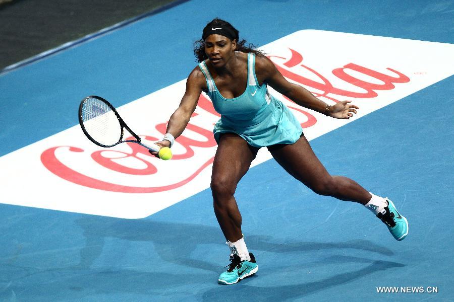 DBS Singapore Slammers player Serena Williams of the United States returns the ball against Manila Mavericks player Kirsten Flipkens of Belgium during the women's singles match in the International Premier Tennis League in Pasay City, the Philippines, on Nov. 30. 2014. 