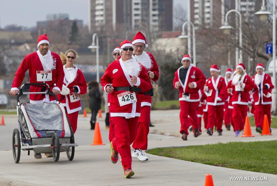 Participants dressed as Santa Claus take part in the 2014 Santa Race in Hamilton, Ontario, Canada, Nov. 30, 2014.