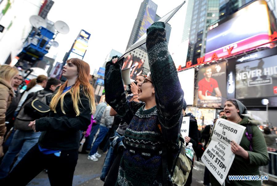 People take part in a protest in New York, the United States, on Dec. 1, 2014.