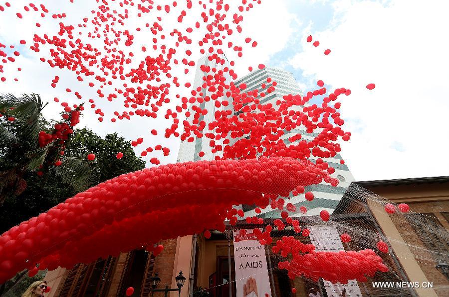 Residents participate in a meeting to commemorate the 'World AIDS Day', held in the Revolution Monument, in Mexico City, capital of Mexico, on Dec. 1, 2014. 