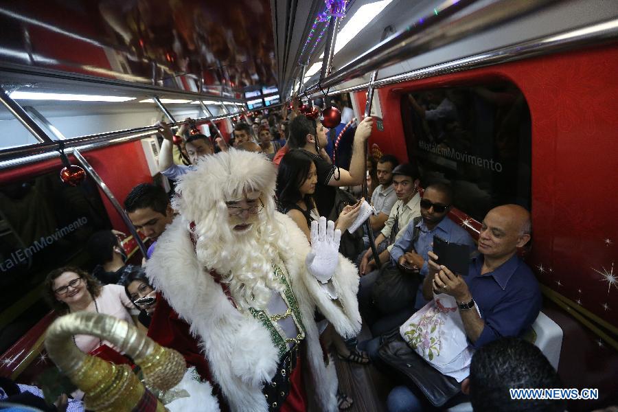 An actor disguised as Santa Claus travels in a wagon of the Sao Paulo Metro Yellow Line, in the city of Sao Paulo, Brazil, on Dec. 1, 2014.