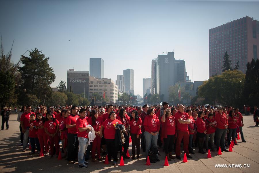 Residents participate in a meeting to commemorate the 'World AIDS Day', held in the Revolution Monument, in Mexico City, capital of Mexico, on Dec. 1, 2014. 