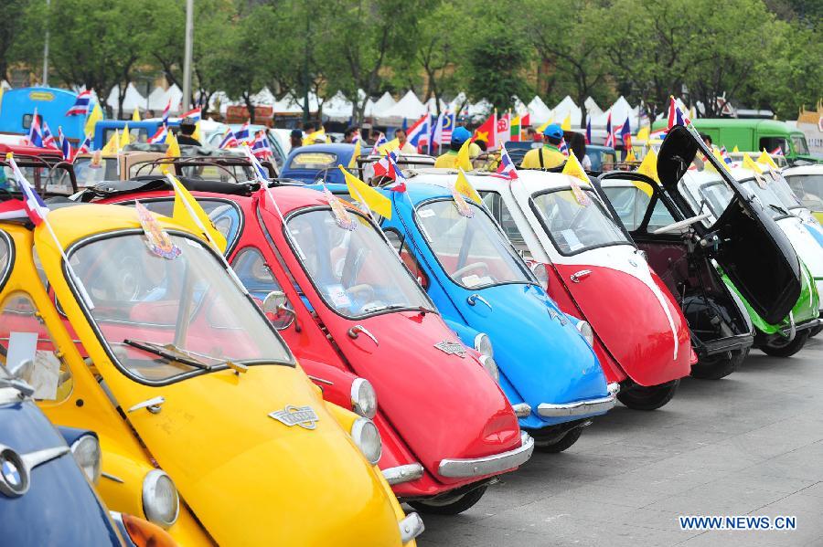 Antique cars are seen during a parade as part of the celebration of Thai King's 87th Birthday Anniversary in front of Grand Palace in Bangkok, Thailand, Dec. 4, 2014. 