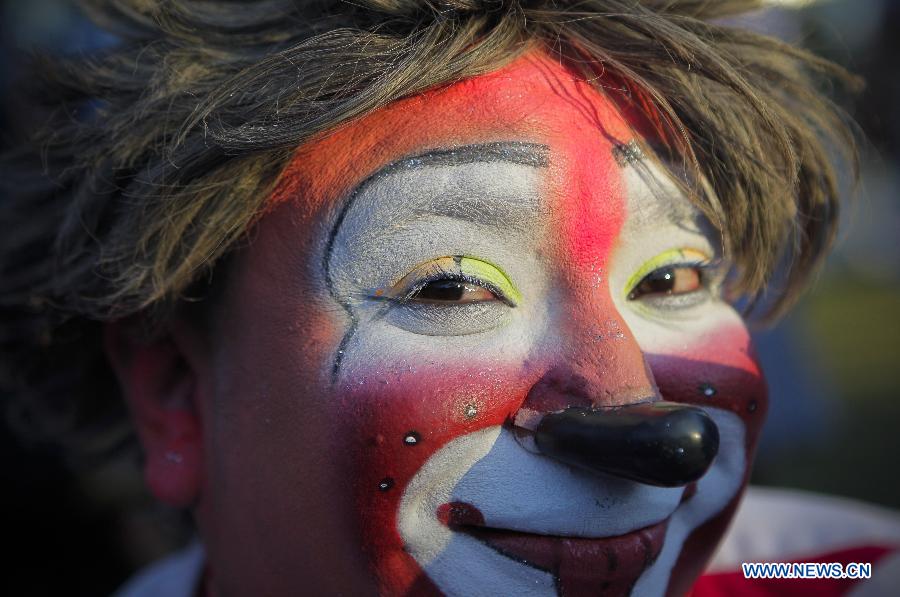 A Salvadoran clown takes part in a show at the Beethoven Fountains marking the 'National Day of the Salvadoran Clown' in San Salvador, capital of El Salvador, on Dec. 3, 2014. 