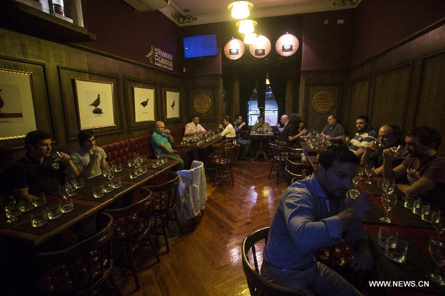 Visitors participate in a whisky catering in the Museum of Whisky in Buenos Aires, capital of Argentina, on Dec. 4, 2014. 