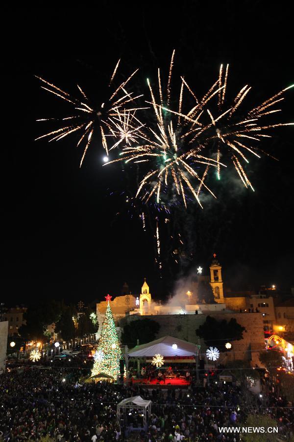 Fireworks are seen during the lighting ceremony of the Main Christmas tree at the Manger Square, outside the Church of the Nativity in West Bank city of Bethlehem on Dec. 6, 2014. (Xinhua/ Luay Sababa)