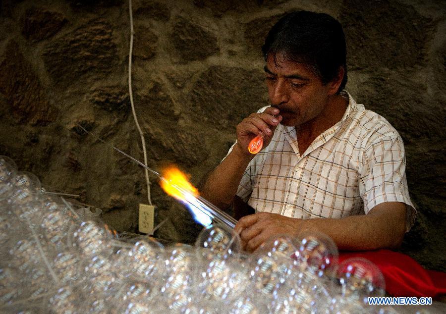 Image taken on Dec. 6, 2014 shows a man making a sphere in Tlalpujahua of Michoacan State, Mexico. The Magic Town of Tlalpujahua is renowned for its Christmas spheres created by its artisans.