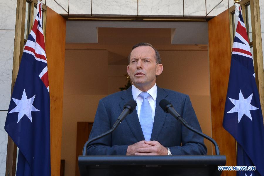 Australian Prime Minister Tony Abbott delivers a short speech at a press conference in the Parliament House hours after a few gunmen took people hostage in a cafe in Sydney CBD, in Canberra, Australia, Dec. 15, 2014. 