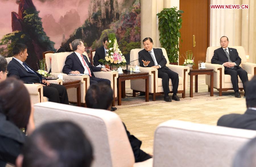 Liu Yunshan (2nd R), a member of the Standing Committee of the Political Bureau of the Communist Party of China (CPC) Central Committee, meets with media delegates from ASEAN countries, Japan and South Korea, who were in China to attend the seventh 10+3 media seminar, in Beijing, capital of China, Dec. 17, 2014. (Xinhua/Ma Zhancheng)