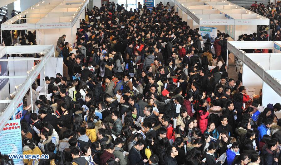 Job seekers attend a job fair for postgraduates in Beijing, capital of China, Dec. 18, 2014. About 18,000 opportunities were offered at the fair. (Xinhua/Li Wen)