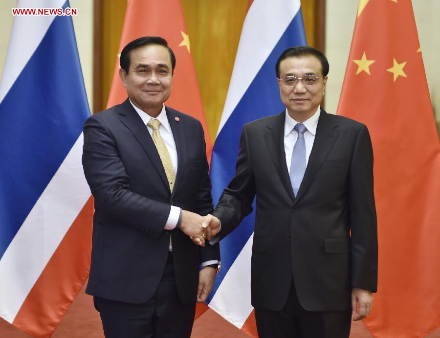 Chinese Premier Li Keqiang (R) shakes hands with visiting Thai Prime Minister Prayuth Chan-ocha before their talks in Beijing, capital of China, Dec. 22, 2014. 