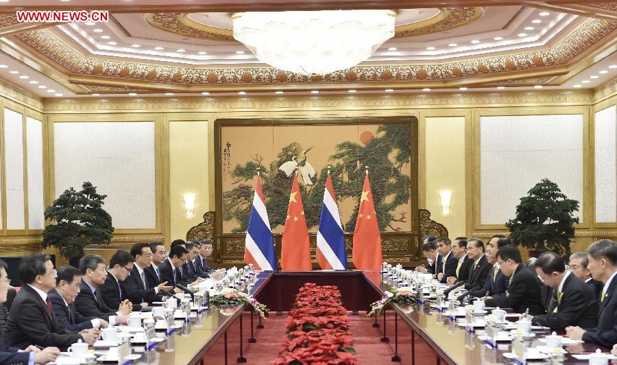 Chinese Premier Li Keqiang (R) shakes hands with visiting Thai Prime Minister Prayuth Chan-ocha before their talks in Beijing, capital of China, Dec. 22, 2014. 