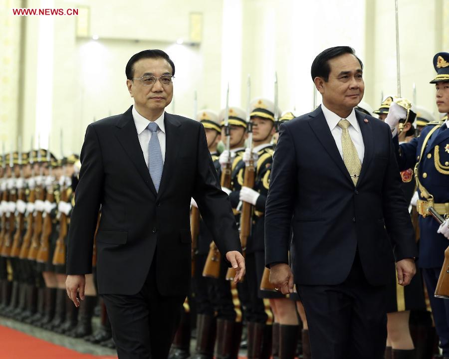 Chinese Premier Li Keqiang (R) shakes hands with visiting Thai Prime Minister Prayuth Chan-ocha before their talks in Beijing, capital of China, Dec. 22, 2014. 