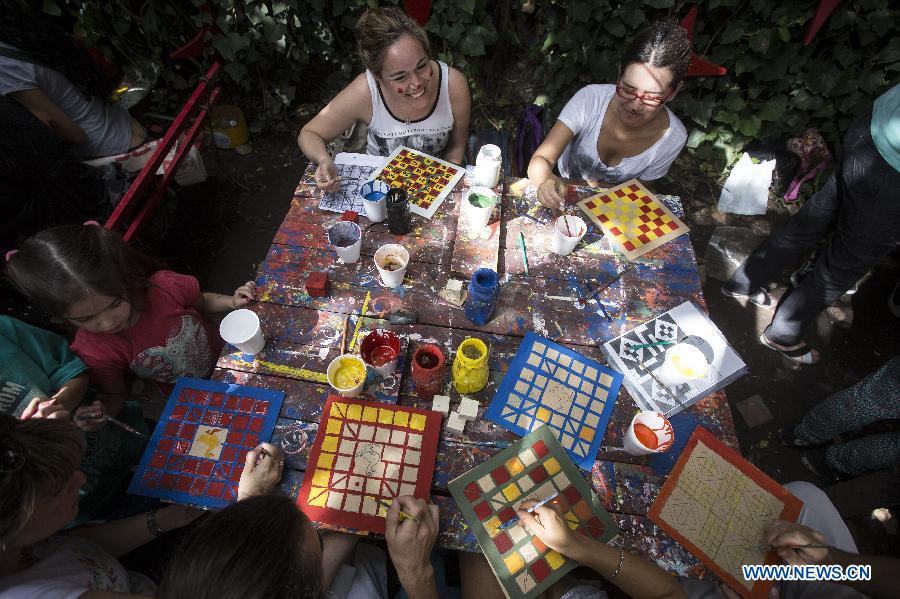 Volunteers create wooden educational toys that will be donated to children from low-income family in the 'Si' Foundation Toy Factory in Buenos Aires City, capital of Argentina, on Dec. 21, 2014. Up until now, over 5,600 toys created by around 6,000 volunteers have been sent to children in different cities in Argentina, according to local media. (Xinhua/Martin Zabala)