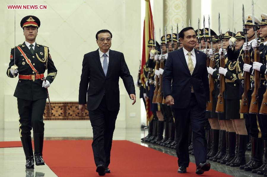 Chinese Premier Li Keqiang (R) shakes hands with visiting Thai Prime Minister Prayuth Chan-ocha before their talks in Beijing, capital of China, Dec. 22, 2014. 