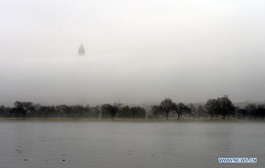 The Washington Monument is seen through thick fog in Washington D.C., the United States, Dec. 24, 2014.