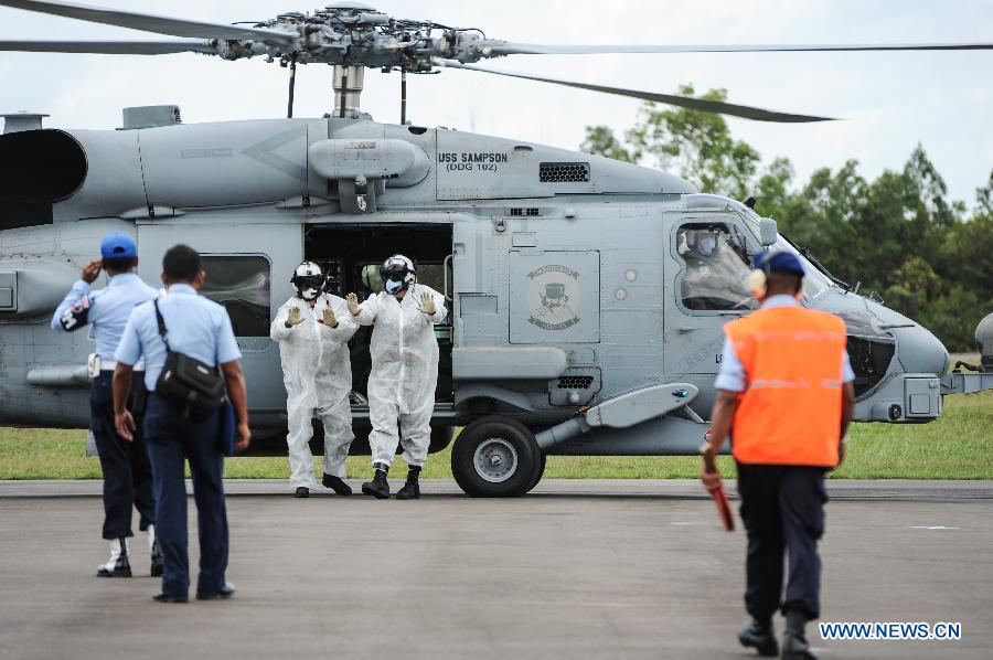 A USS Navy helicopter carrying the bodies of four victims of AirAsia flight QZ8501 lands at Iskandar Air Base, in Pangkalan Bun, Central Kalimantan, Indonesia, Jan. 2, 2015. 