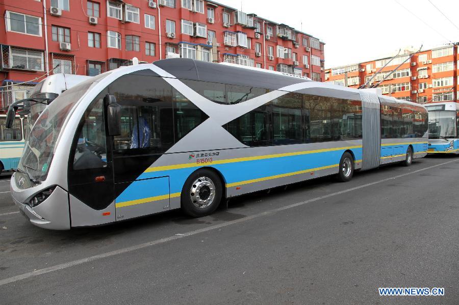 Photo taken on Jan. 7, 2015 shows a brand-new electric bus, 18 meters in length, at the Fuchengmen Outer street bus terminal in Beijing, capital of China. This batch of electric buses will put into operation recently.