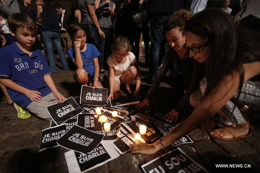 People take part in a gathering mourning the people killed in an attack at the Paris offices of weekly newspaper 'Charlie Hebdo', in Sao Paulo, Brazil, on Jan. 7, 2015.