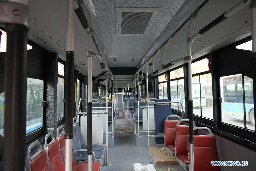 Photo taken on Jan. 7, 2015 shows a brand-new electric bus, 18 meters in length, at the Fuchengmen Outer street bus terminal in Beijing, capital of China. This batch of electric buses will put into operation recently.