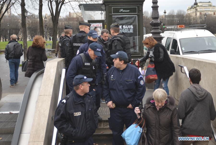 Police walk into a metro station in Paris, France, Jan. 8, 2015. Paris is beefing up security in precaution after Wednesday's deadly terrorist which left 12 people killed and 11 others injured.