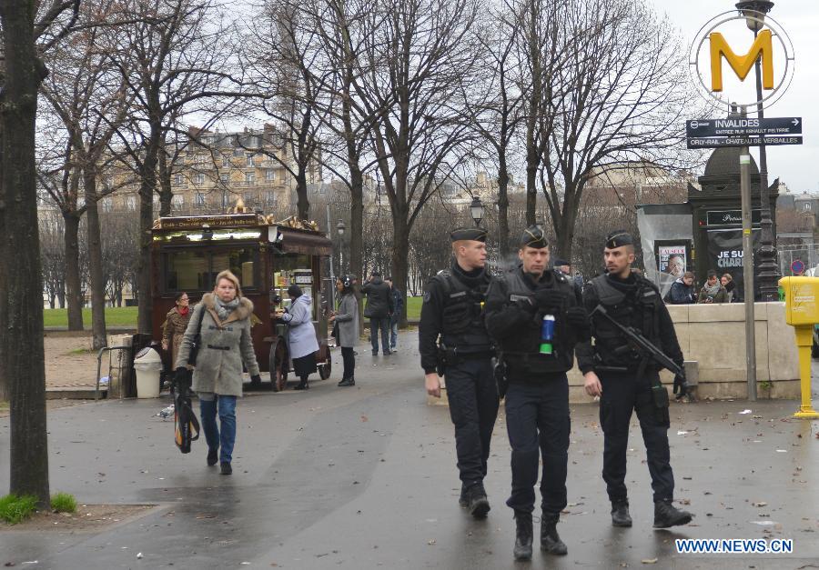 Police walk into a metro station in Paris, France, Jan. 8, 2015. Paris is beefing up security in precaution after Wednesday's deadly terrorist which left 12 people killed and 11 others injured.