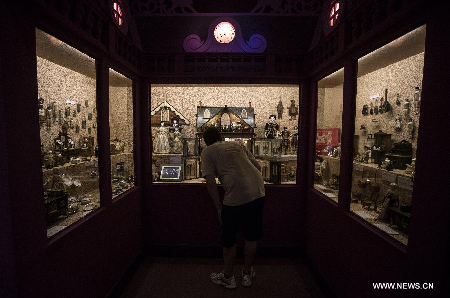 A visitor views ancient dolls shown during the exhibit 'Once upon a time... Dolls and Toys (1870-1940)', in the Hispanic American Art Museum 'Isaac Fernandez Blanco', in Buenos Aires, Argentina, on Jan. 9, 2015.