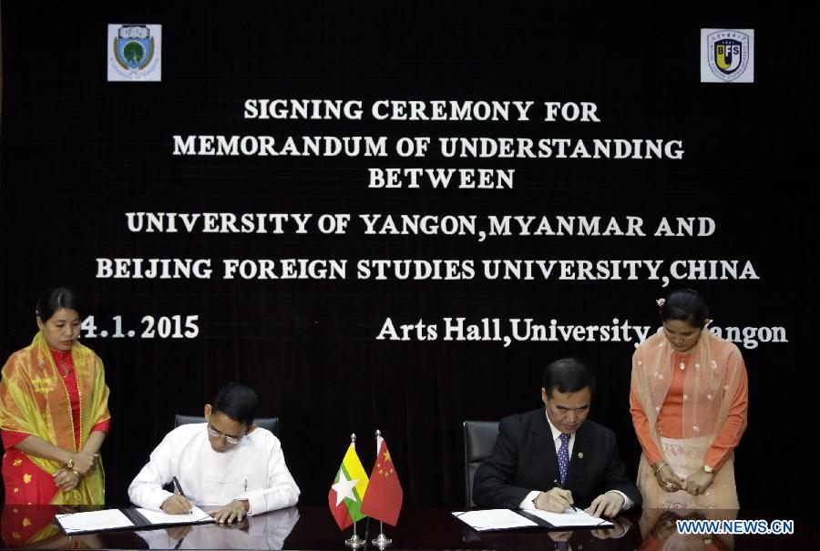 Dr. Yan Guohua (2nd R), vice president of Beijing Foreign Studies University, and Dr. Aung Thu (2nd L), rector of the University of Yangon, sign a memorandum of understanding between University of Yangon, Myanmar and Beijing Foreign Studies University, China at University of Yangon in Yangon, Myanmar, Jan. 14, 2015. Myanmar's University of Yangon and Yangon University of Foreign Language (YUFL) signed memorandums of understanding respectively with the Beijing Foreign Studies University (BFSU) of China here Wednesday on educational exchange and strengthening ties between the two nations. (Xinhua/U Aung) 