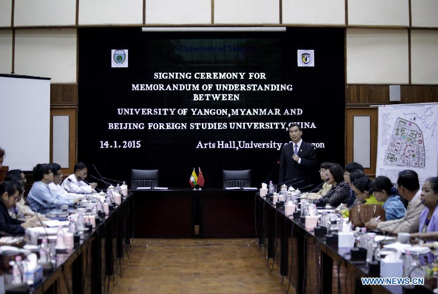 Photo taken on Jan. 14, 2015 shows a scene of signing ceremony for a memorandum of understanding between University of Yangon, Myanmar and Beijing Foreign Studies University, China at University of Yangon in Yangon, Myanmar. Myanmar's University of Yangon and Yangon University of Foreign Language (YUFL) signed memorandums of understanding respectively with the Beijing Foreign Studies University (BFSU) of China here Wednesday on educational exchange and strengthening ties between the two nations. (Xinhua/U Aung) 