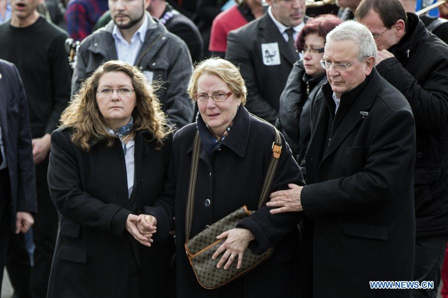 People attend the funeral of slain Charlie Hebdo editor-in-chief Stephane Charbonnier (who publishes under the pen name Charb) in Pontoise, outside Paris, Jan. 16, 2015.