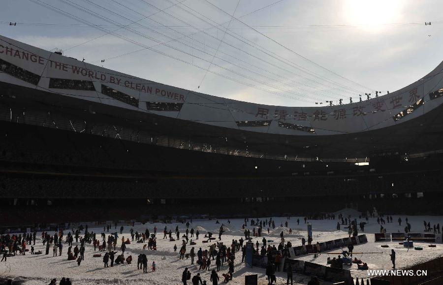 Citizens enjoy their weekend leisure time in a seasonal snow park at the National Stadium, or the Bird's Nest, in Beijing, capital of China, Jan. 17, 2015.