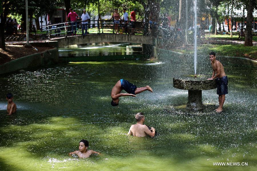 Children cool off in a public fountain in downtown Sao Paulo, Brazil, on Jan. 19, 2015. 