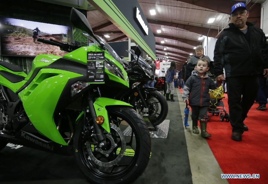 Visitors check out motorcycles displayed at the Vancouver International Motorcycle Show at Tradex center in Abbotsford, Canada, Jan. 23, 2015.