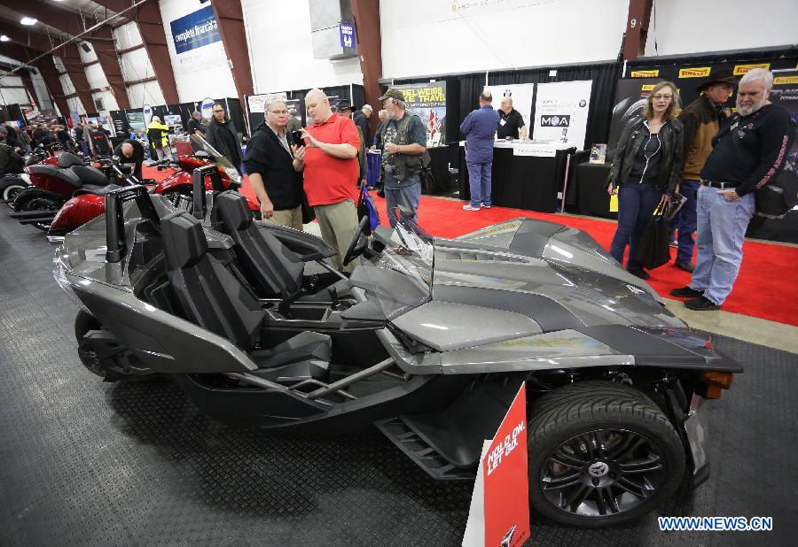 Visitors look at an three-wheeler displayed at the Vancouver International Motorcycle Show at Tradex center in Abbotsford, Canada, Jan. 23, 2015. 