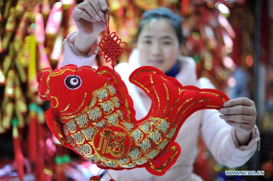 A citizen shows an ornament bought at a shopping mall in Yinchuan, capital of northwest China's Ningxia Hui Autonomous Region, Feb. 2, 2015. 