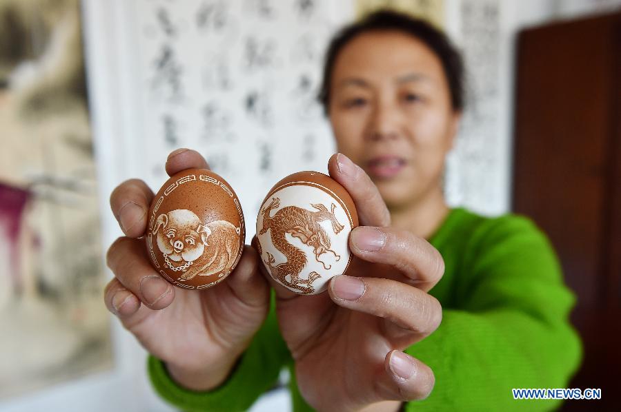 Ming Xia, a citizen of Shizuishan City, shows her egg handicrafts in a cultural center in Shizuishan City, northwest China's Ningxia Hui Autonomous Region, Feb. 4, 2015. 