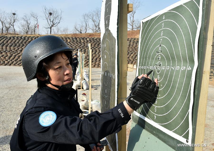 A total of 140 members of Chinese riot squad, who will start off in March for an eight-month United Nations peace-keeping mission in Liberia, took part in a drill in Jinan on Monday.