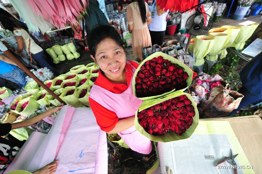 A vendor displays flowers ahead of Valentine's Day at Pak Klong Talad market in Bangkok, Thailand, Feb. 13, 2015.