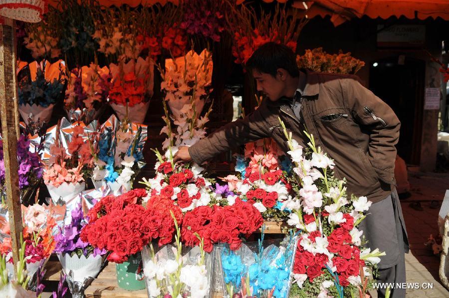 A vendor arranges flowers as he waits for customers in Islamabad, capital of Pakistan on Feb. 13, 2015, a day before Valentine's Day. 