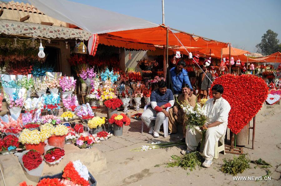 A vendor arranges flowers as he waits for customers in Islamabad, capital of Pakistan on Feb. 13, 2015, a day before Valentine's Day. 