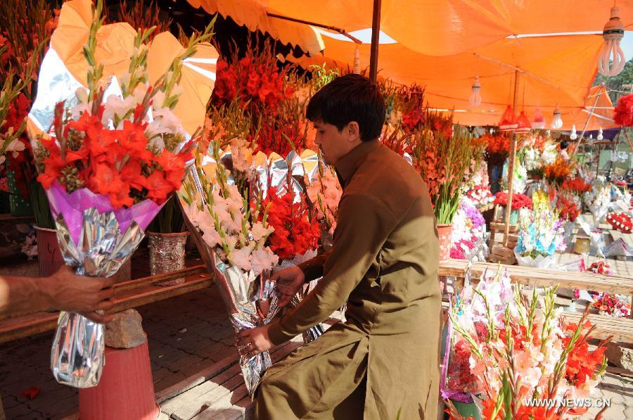 A vendor arranges flowers as he waits for customers in Islamabad, capital of Pakistan on Feb. 13, 2015, a day before Valentine's Day. 