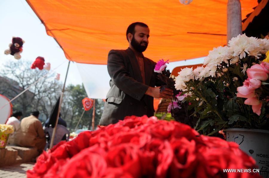 A vendor arranges flowers as he waits for customers in Islamabad, capital of Pakistan on Feb. 13, 2015, a day before Valentine's Day. 