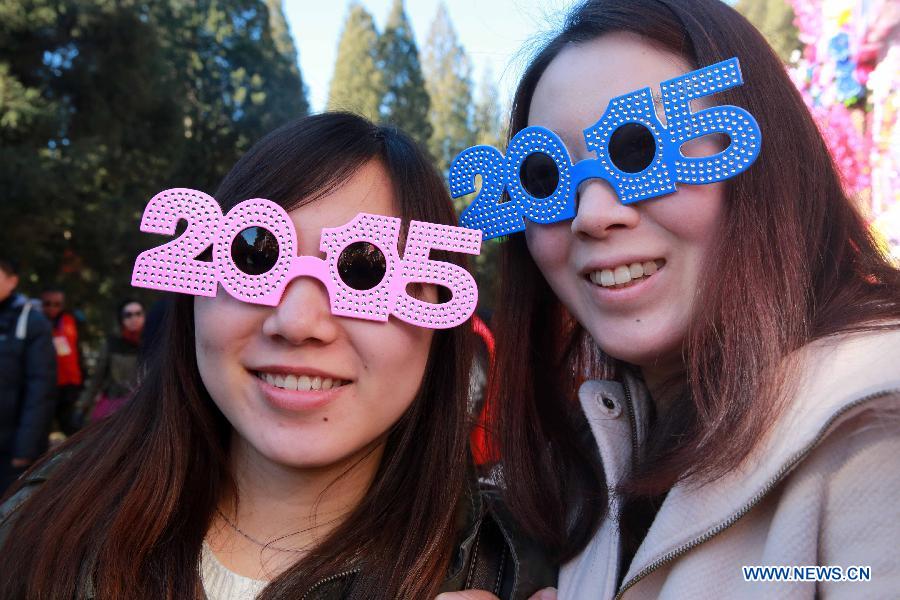 Girls wearing their 2015 glasses visit the annual temple fair at Ditan Park, also known as the Temple of Earth, Feb. 18, 2015.