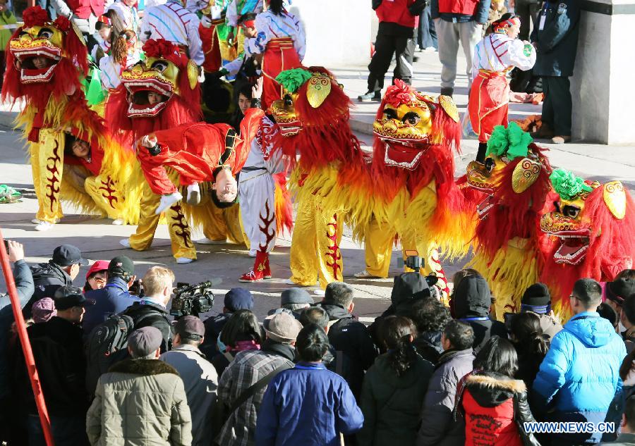 Visitors watch a lion dance during the opening of the annual temple fair at Ditan Park, also known as the Temple of Earth, Feb. 18, 2015.